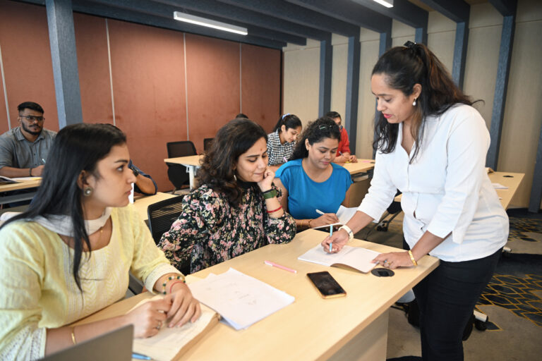 Teacher explaining mature adult students in a classroom